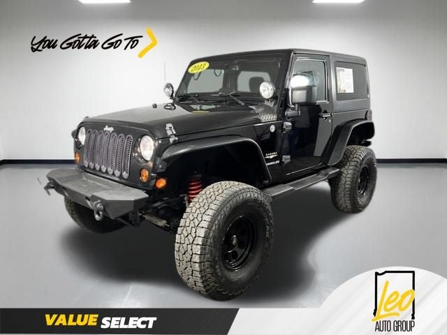 2013 Jeep Wrangler Sahara in Black — front three-quarter view