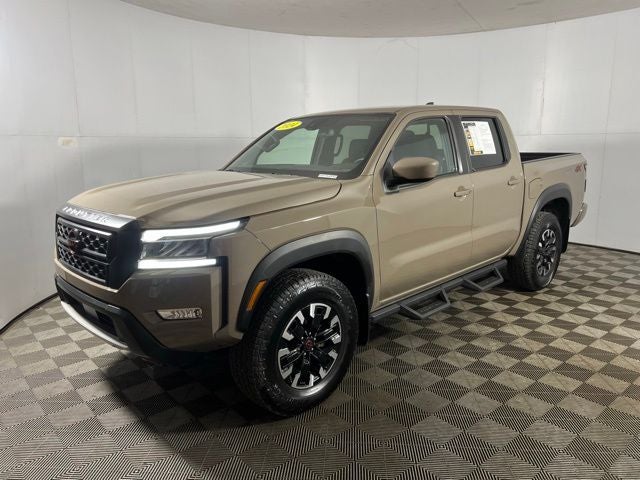 2024 Nissan Frontier Crew Cab PRO-4X in Baja Storm — front three-quarter view
